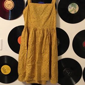 Mini yellow dress with polka dot poms on it